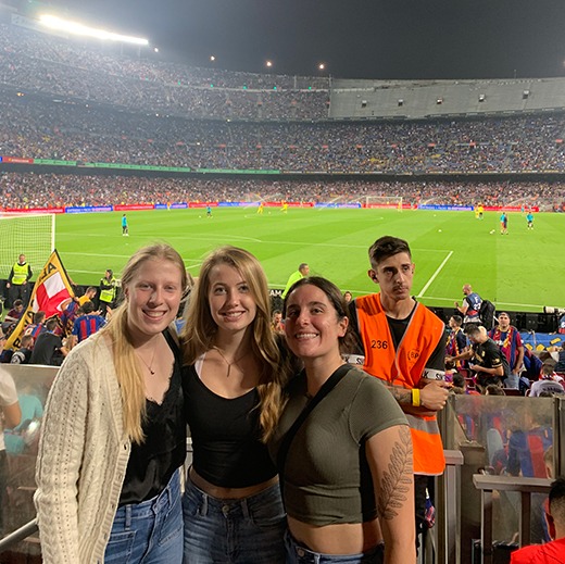 Angie at a soccer game with two friends