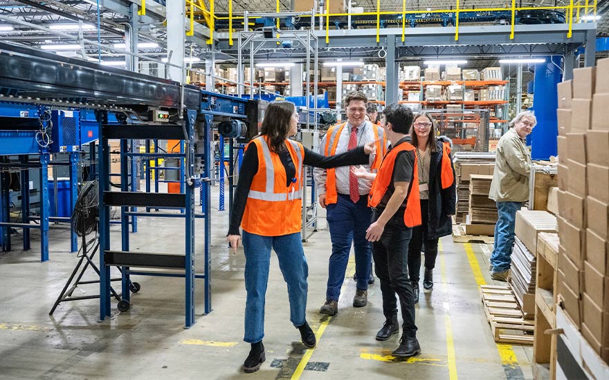 WSB undergrads wearing safety vests tour the Kohler facility