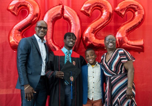 WSB graduate Jovaughn Bowen poses with his family, father Garfield; brother Jordaine; and mother Mauvalyn Bowen, before the Spring 2022 Undergraduate Program Graduation Celebration at the Alliant Energy Center on Friday, May 13, 2022.  (Paul L. Newby, II /UW-Madison Wisconsin School of Business)