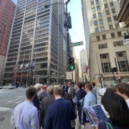 Chris Carol discussing a building on LaSalle Street with students 