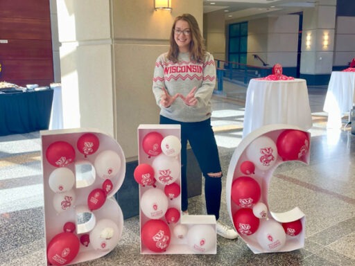 Katie Lorenz standing in front of the letters BLC