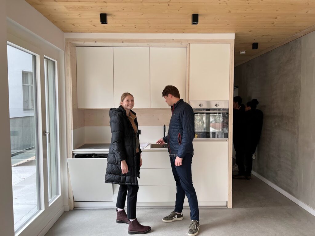 Individuals inspecting the kitchen in the new Berlin condo development