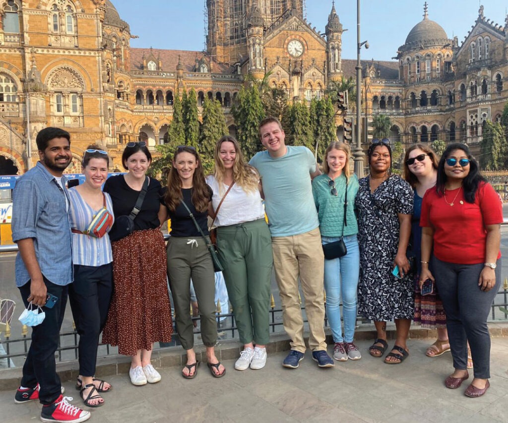 A group of people posing in front of a building