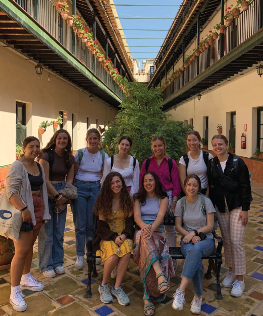 A group of women posing in court yard