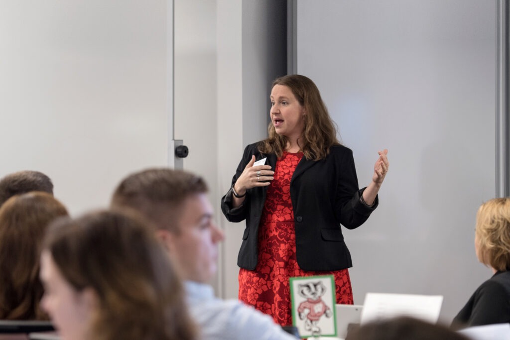 A woman standing and talking to an MBA class