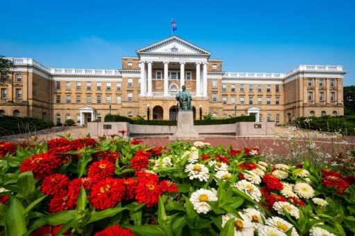 Bascom Hall with red and white flowers.