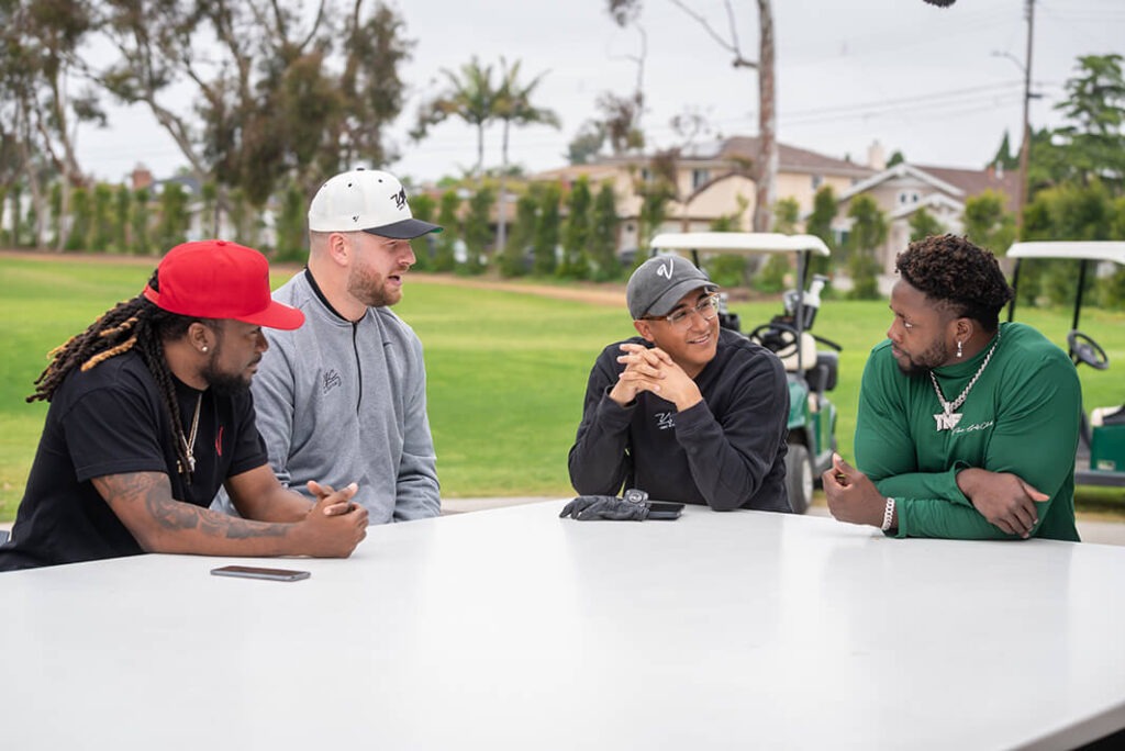 Noe talking with friends at a table