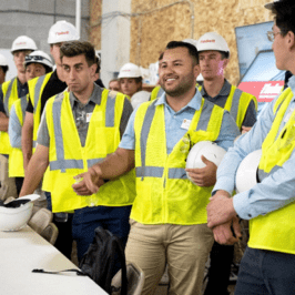 Students gather for a presentation at a development site tour