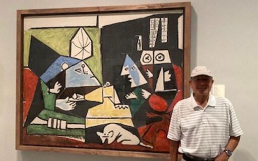 Feldman standing next to museum painting