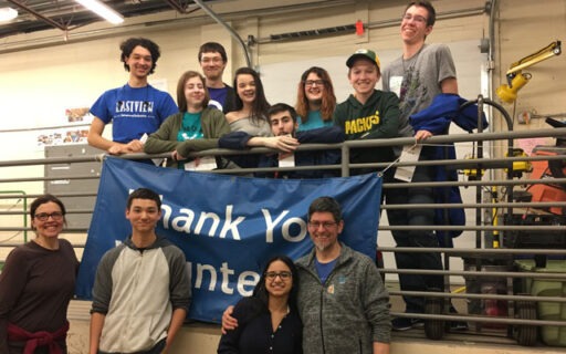 Teens posing with a Thank You Volunteers sign