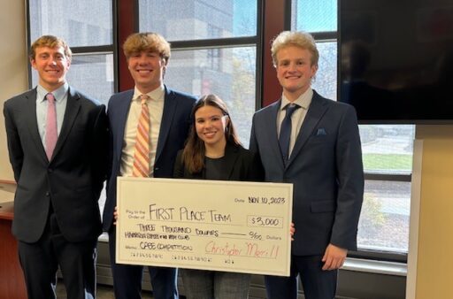 The first place team holding their prize check