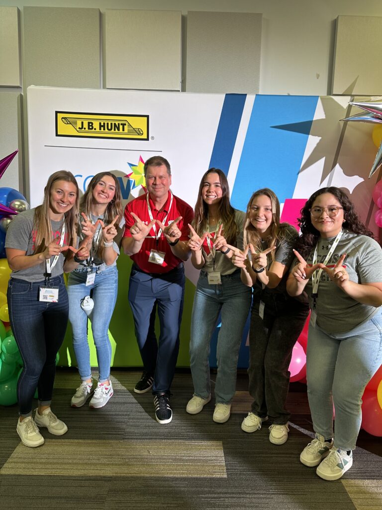 Breanna Schneider, Skylar Rotter, Sasha Kryazh, Natalie Thoms, and Brenda De La Torre in front of women in trucking semitruck