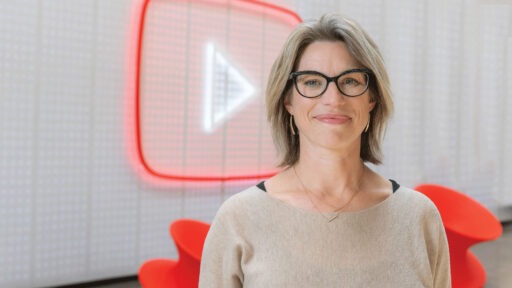 Danielle Tiedt smiling in front of youtube logo