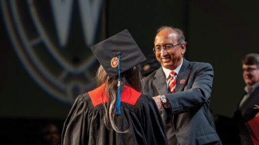 Dean Samba handing a diploma to a graduate