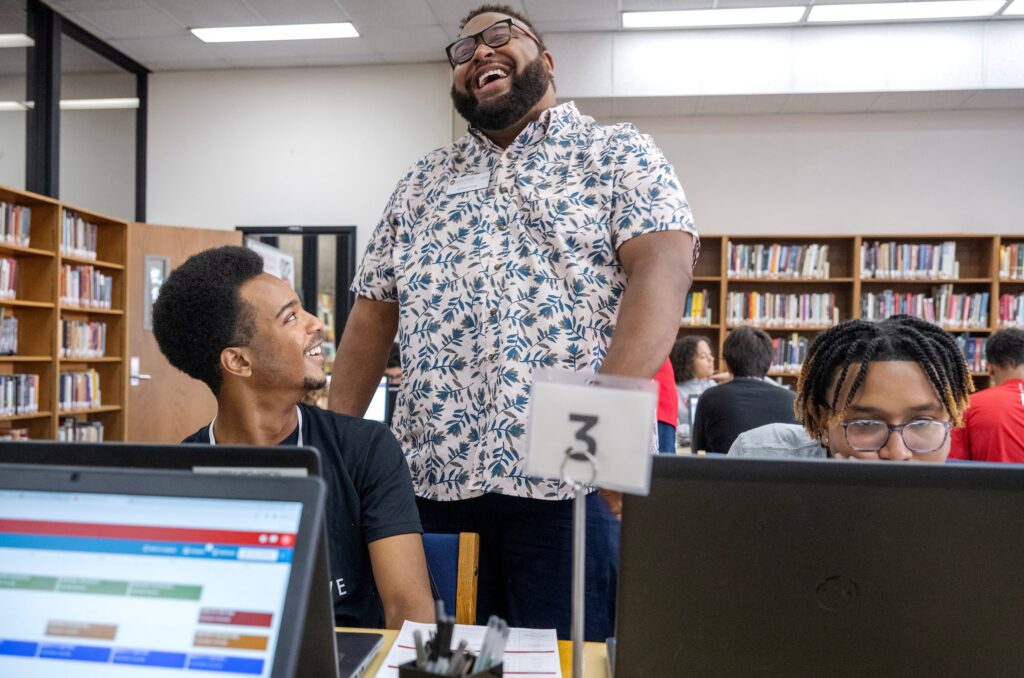 Advisor Anthony Turner Jr. shares a laugh with a SOAR program student
