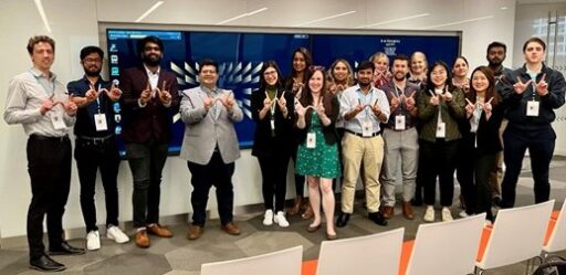 MBA students showing the W hand signal in front of a room during their Mexico trip