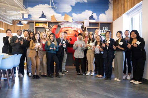 Undergraduate students throw up the “W” during a two-day Consulting Trek in Chicago, where they visited Kemper, Kraft Heinz, and Spaulding Ridge.
