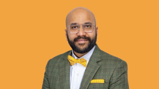 Yash Babar in front of an orange background