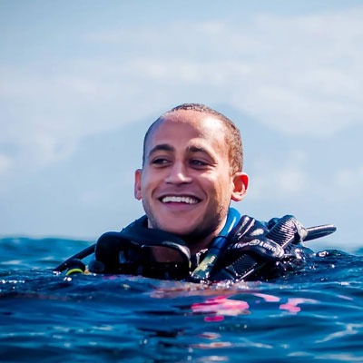 Bracy smiling as he floats in water