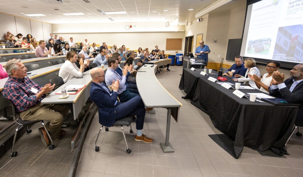 A panel discussion takes place in a classroom