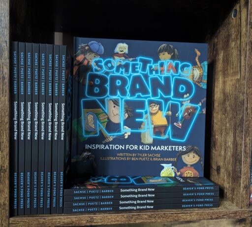 Several books of "Something Brand New: Inspiration for Kid Marketers" on a shelf