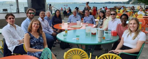 Some Risk Management and Insurance MBA students, alumni, faculty, and staff sitting at the Memorial Union Terrace after orientation.