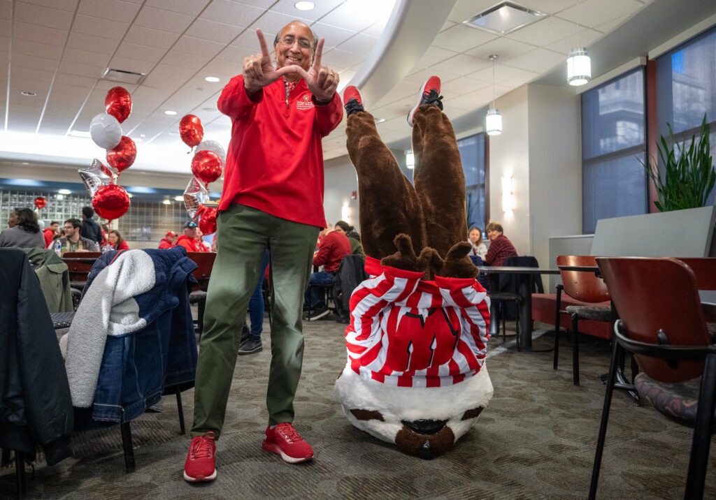 We didn’t know badgers could do that! Bucky Badger performs a headstand—while maintaining a perfect “W”—alongside Vallabh “Samba” Sambamurthy, WSB’s Albert O. Nicholas Dean. 