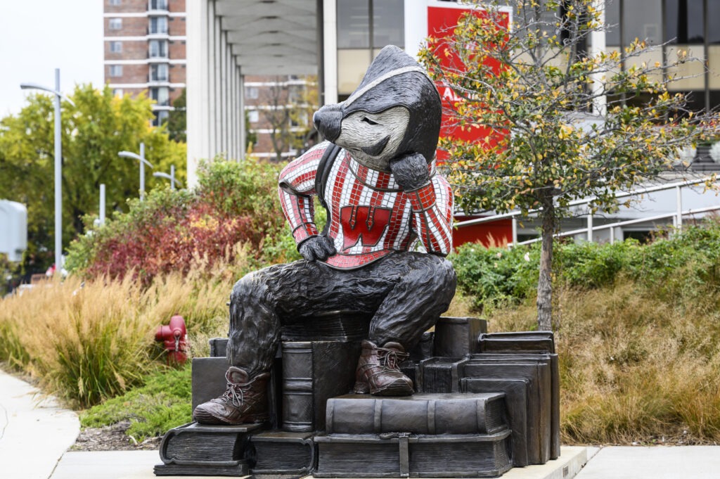 Statue of Bucky sitting on a stack of books at Memorial Union Terrace