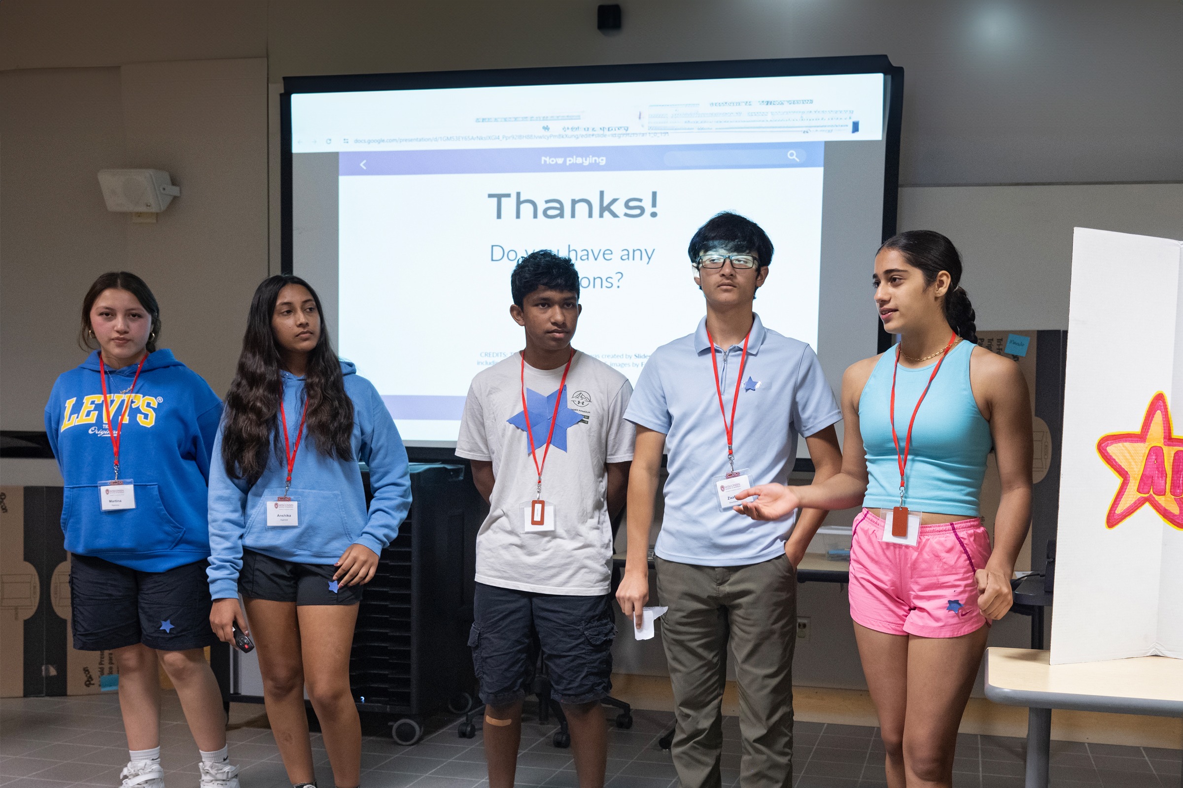 Five students finishing a presentation