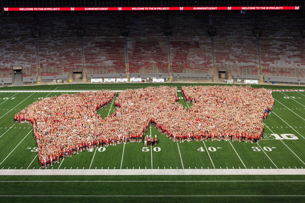 Students who are new to UW-Madison formed a giant "motion W" on the football field at Camp Randall during orientation activities.