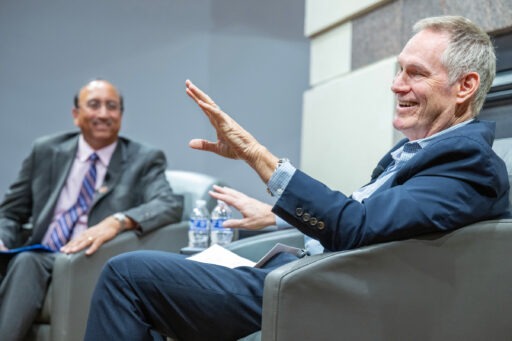 Richard Lane speaking to Vallabh Sambamurthy in front of an MBA audience.