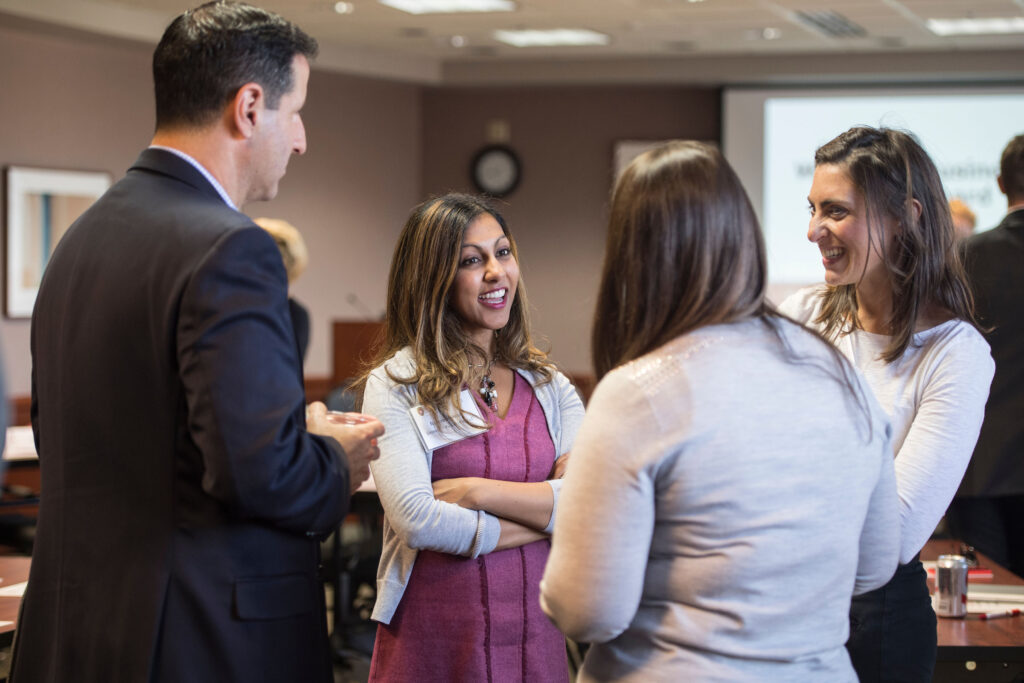 a group of four board members stand in a circle