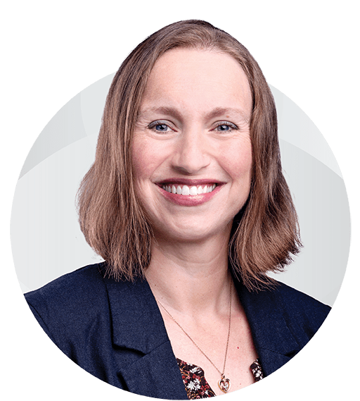 Jean Sink. Woman with short reddish-blonde hair wearing a suit jacket.