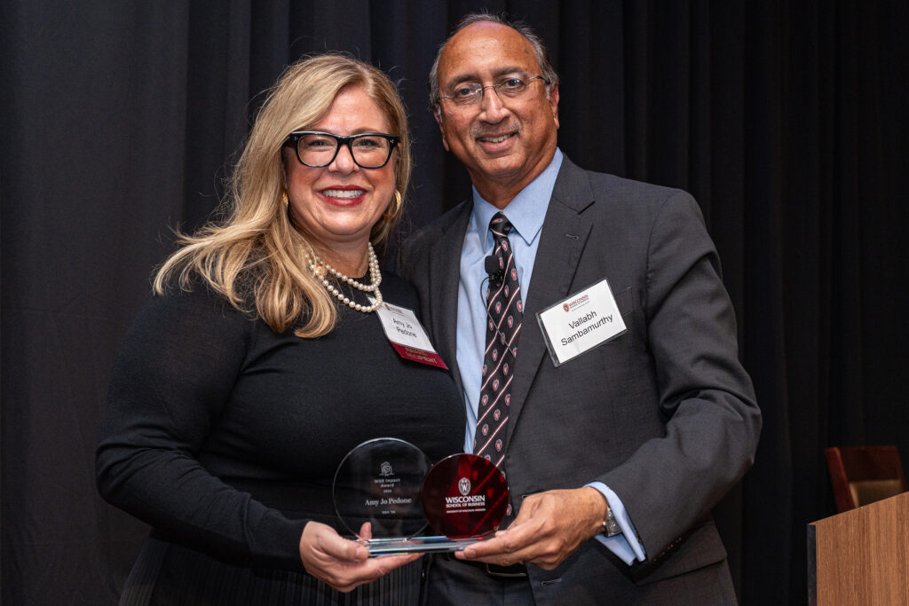 Entrepreneur and master chocolatier Amo Jo Pedone receives the WSB Impact Award from Vallabh “Samba” Sambamurthy, WSB’s Albert O. Nicholas Dean.