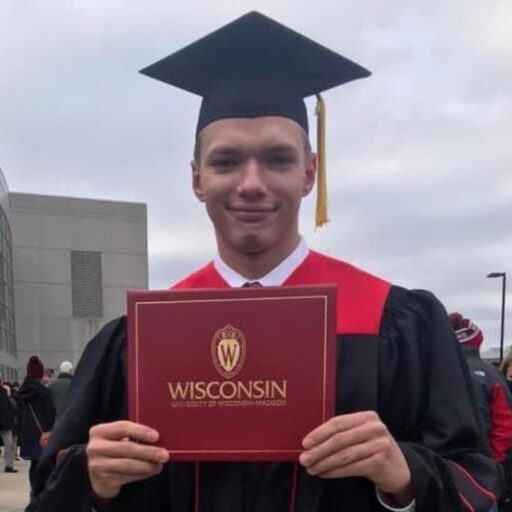 Max Manske in his graduation robes, with a UW-Madison undergrad diploma