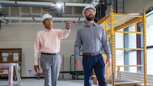 Dean Sambamurthy gets walking with a construction worker through the Grainger Hall renovations.