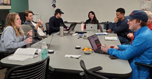 RMI MBA students talking around a conference table