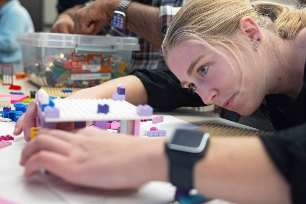 A student takes a close look at her Lego sculpture