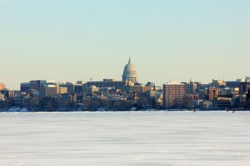 The Wisconsin state capital building with the lake frozen over.