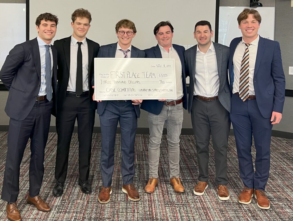 Real Estate Private Equity First Place team holding a $3,000 check
