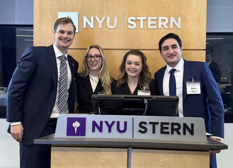 (Left to Right) Stuart Webb, Samantha Lane, Morgan Meyer, and Mario Perez Garcia standing behind a NYU Stern podium