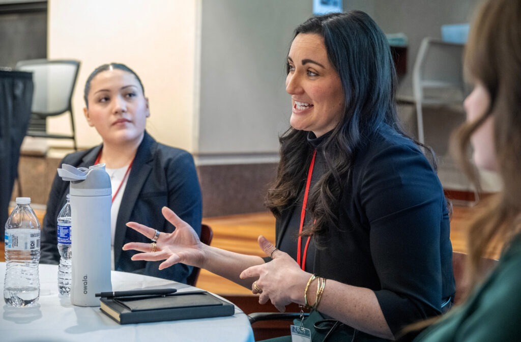 women speaking at table
