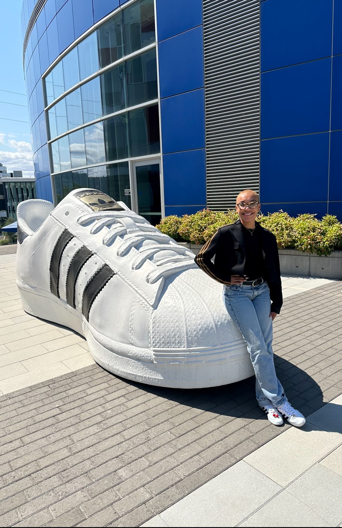 Corinne Wright posing in front of a giant Adidas shoe