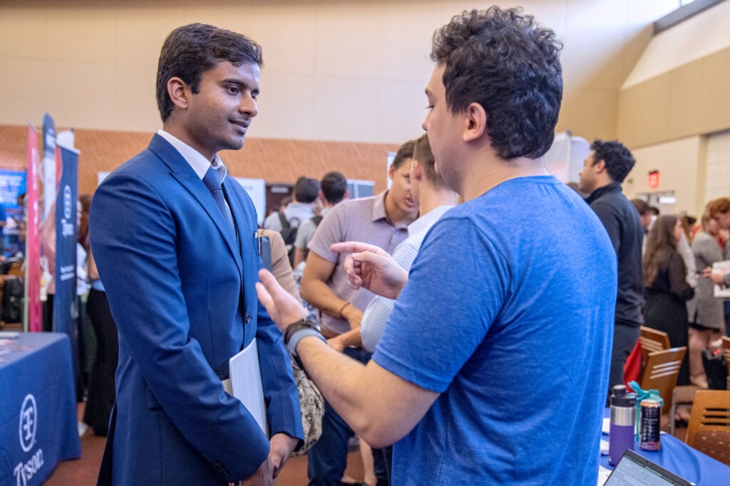 Student talking to recruiter at career fair