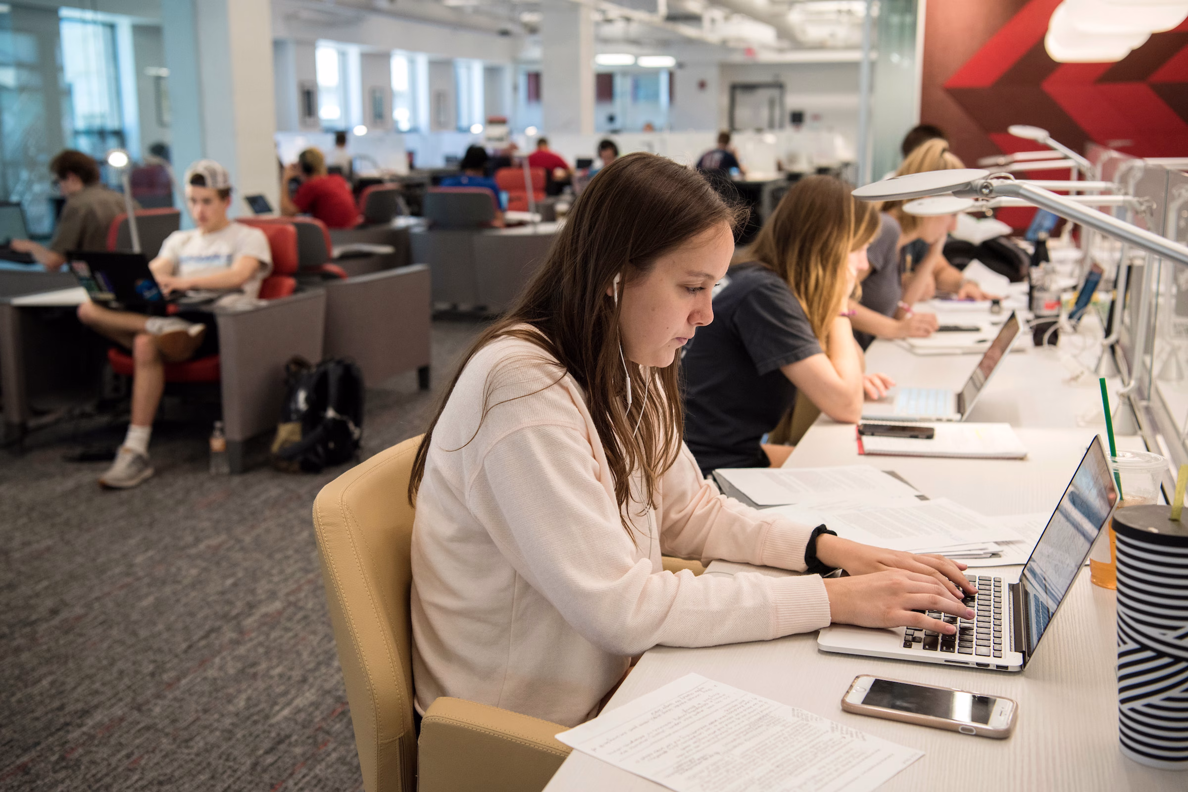 Students sit and work on their laptops in the Learning Commons.