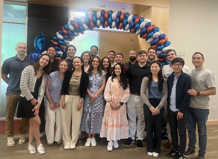 Photograph of 20 UnitedHealth Group Leadership Experience interns standing in front of a balloon arch