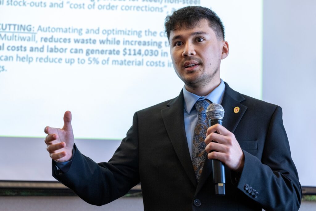 A student presents their consulting project results to the advisory board.