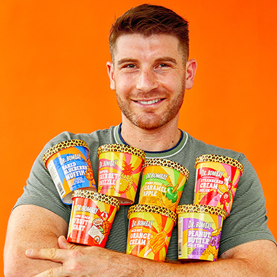 Sam Rockwell holds tubs of his company's ice cream, Dr. Bombay.