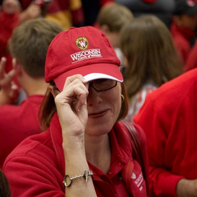 A woman wearing a red UW–Madison hat.