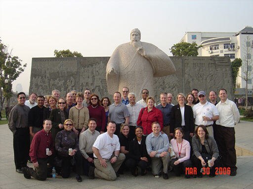 Ed Paradowski, with his Executive MBA peers, poses in front of a statue during his trip to China.